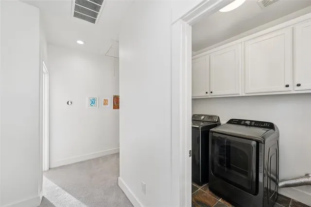 a living room with furniture a fireplace and a dining table with wooden floor