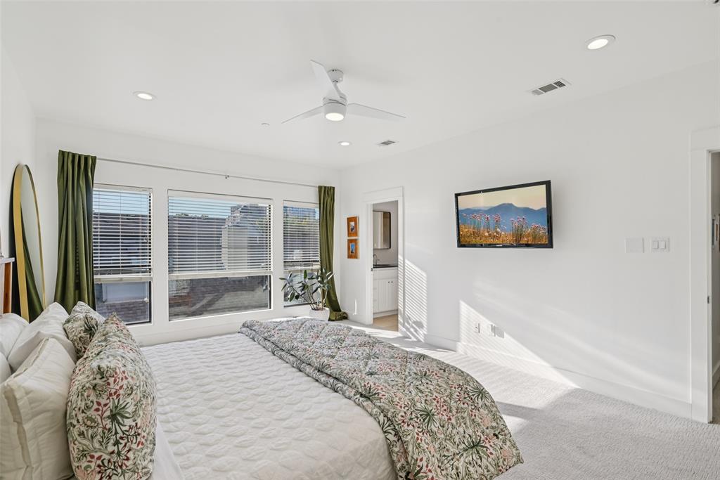 3926 Holland Avenue, Unit 102 Dallas, TX 75219 - Photo 25 of 40 a bedroom with a bed and a large window