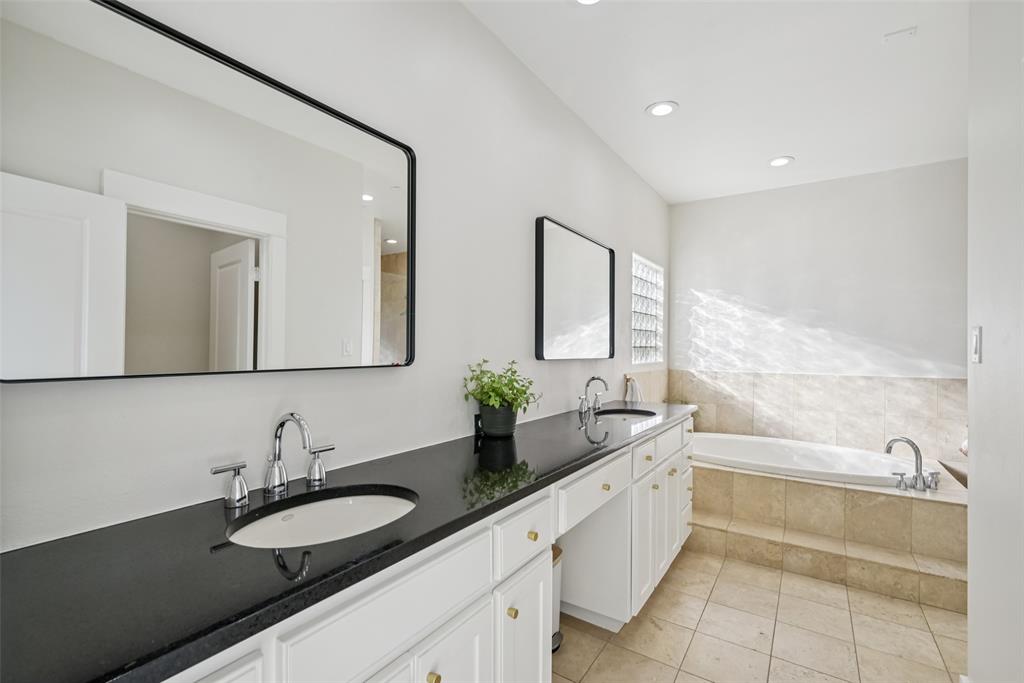 3926 Holland Avenue, Unit 102 Dallas, TX 75219 - Photo 26 of 40 a spacious bathroom with a granite countertop sink and a mirror