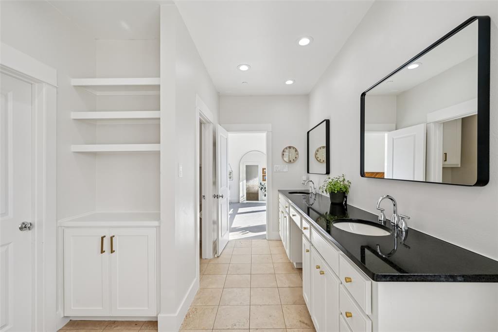3926 Holland Avenue, Unit 102 Dallas, TX 75219 - Photo 27 of 40 a large kitchen with a granite countertop sink and a refrigerator