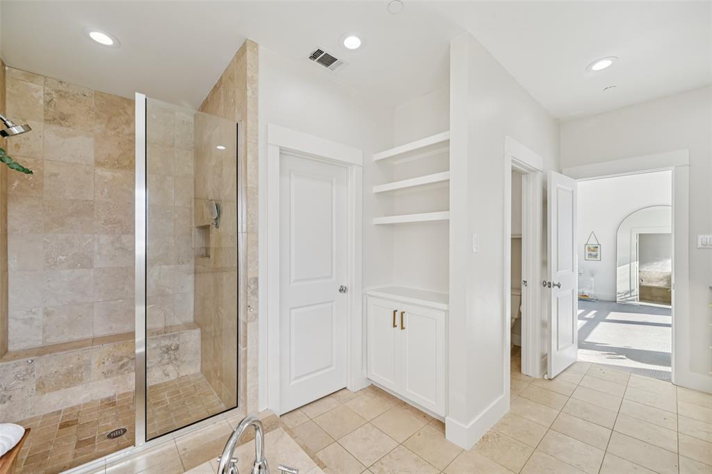 3926 Holland Avenue, Unit 102 Dallas, TX 75219 - Photo 28 of 40 a bathroom with a shower and a glass door