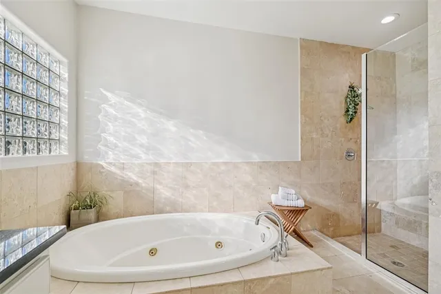 a bathroom with a shower and a glass door