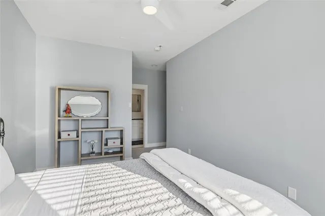 a view of bedroom with baby crib and closet