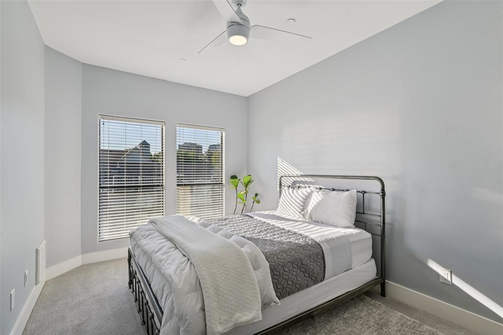3926 Holland Avenue, Unit 102 Dallas, TX 75219 - Photo 32 of 40 a bedroom with a large bed and a large window