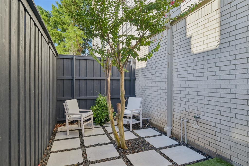 3926 Holland Avenue, Unit 102 Dallas, TX 75219 - Photo 35 of 40 a view of backyard with a chair and potted plants