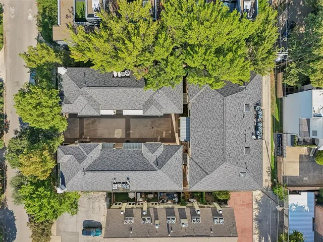an aerial view of a house with a yard