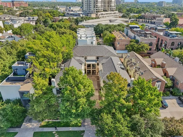 an aerial view of multiple houses with yard