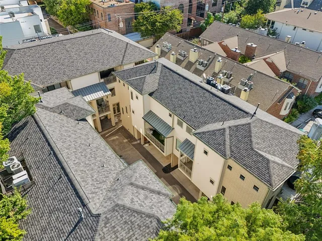 an aerial view of a house with large trees