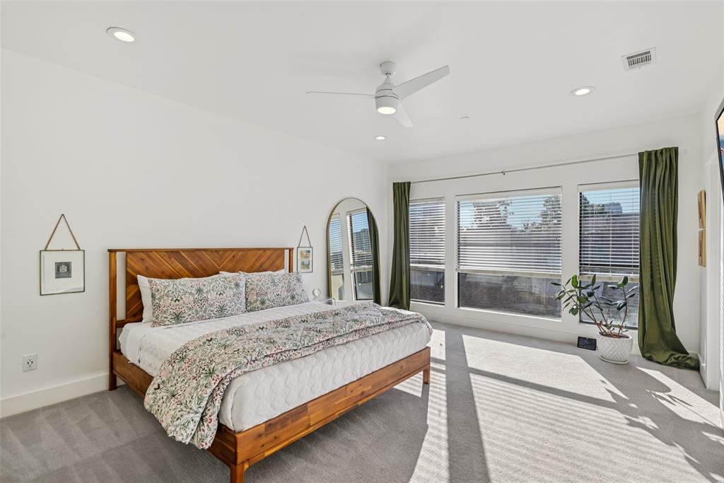 3926 Holland Avenue, Unit 102 Dallas, TX 75219 - Photo 4 of 40 a bedroom with a large bed and a large window