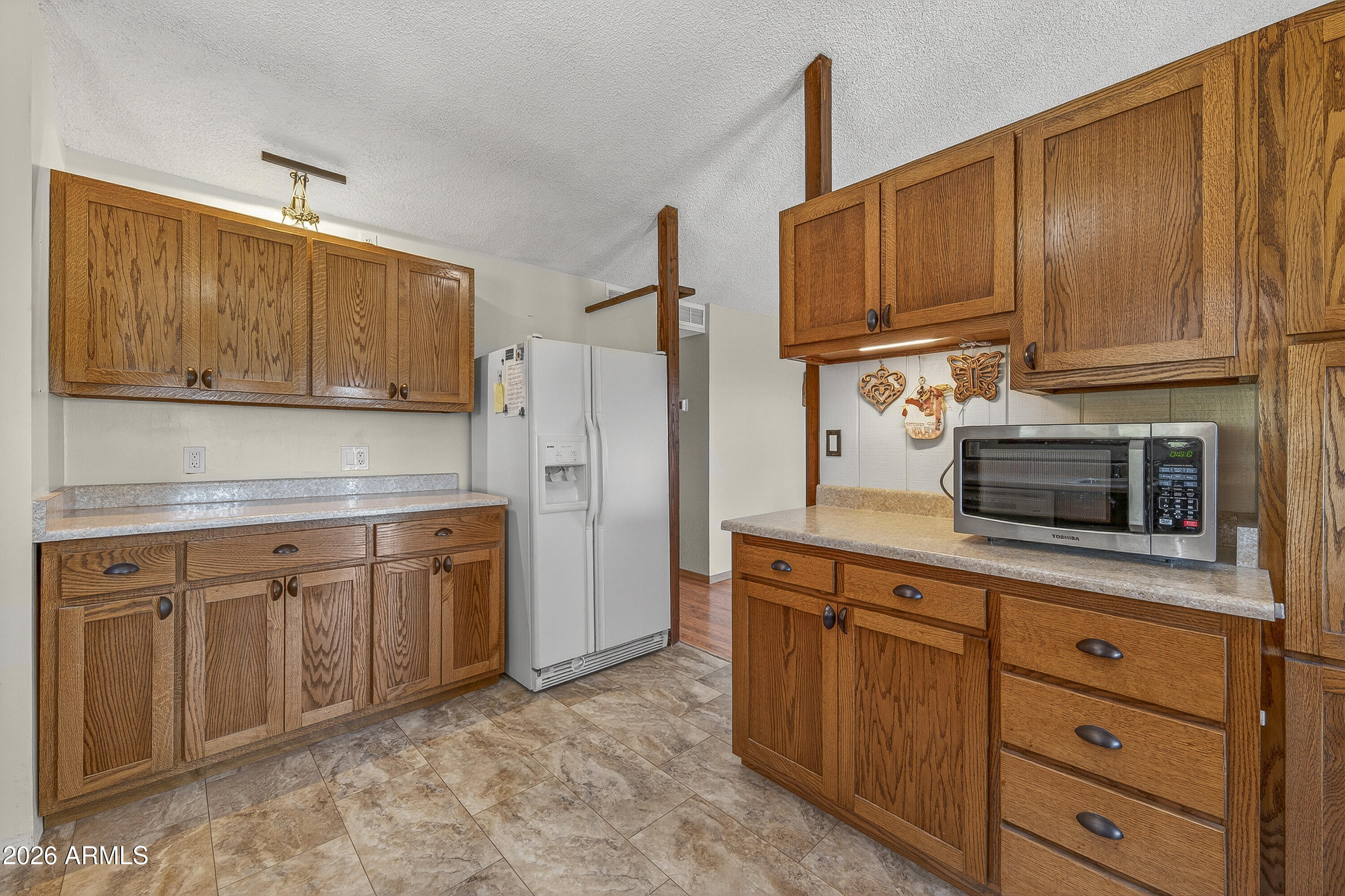 633 Oasis Road Camp Verde, AZ 86322 - Photo 42 of 50 a kitchen with stainless steel appliances granite countertop wooden cabinets a stove top oven a sink and dishwasher