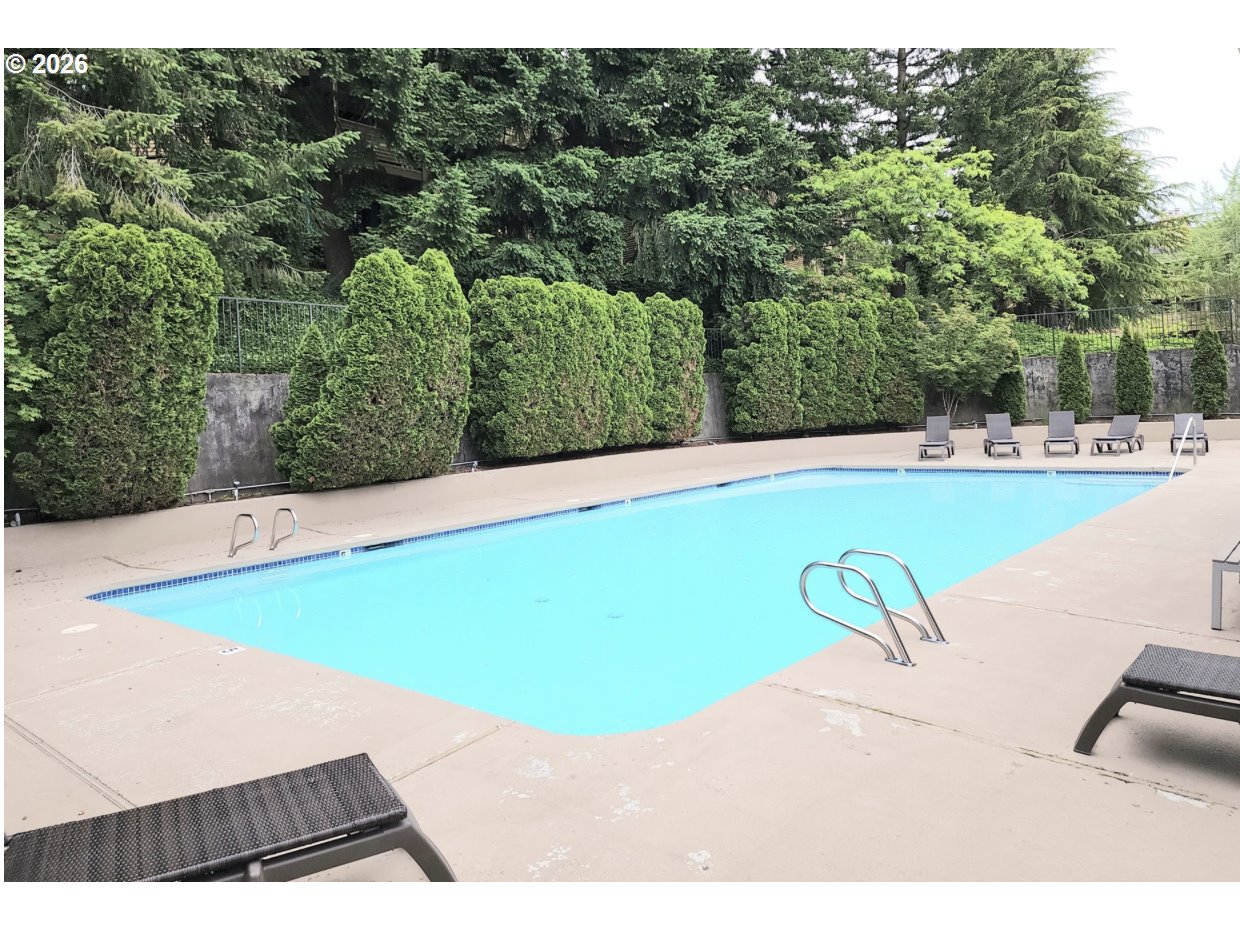 10178 Southeast Talbert Street Clackamas, OR 97015 - Photo 24 of 27 a view of a swimming pool with a yard
