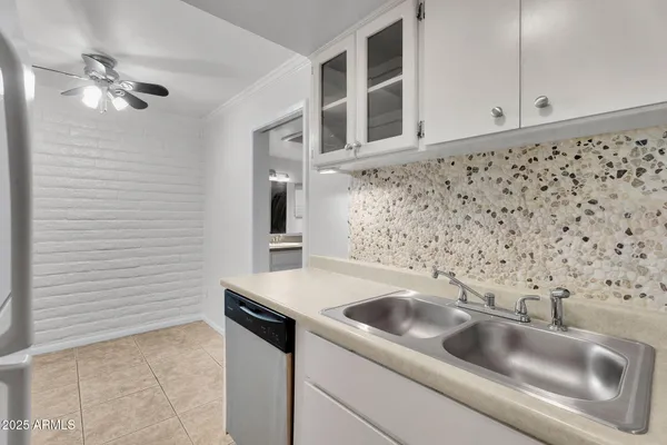 a view of a kitchen with a sink dishwasher and a refrigerator