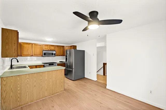 a kitchen with stainless steel appliances a refrigerator and a stove top oven