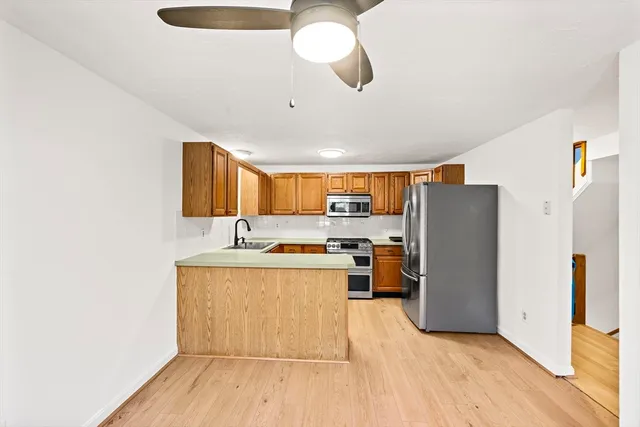 a kitchen with stainless steel appliances a refrigerator and a stove top oven