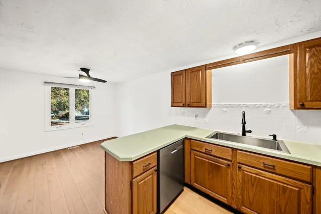 a kitchen with a sink cabinets and wooden floor