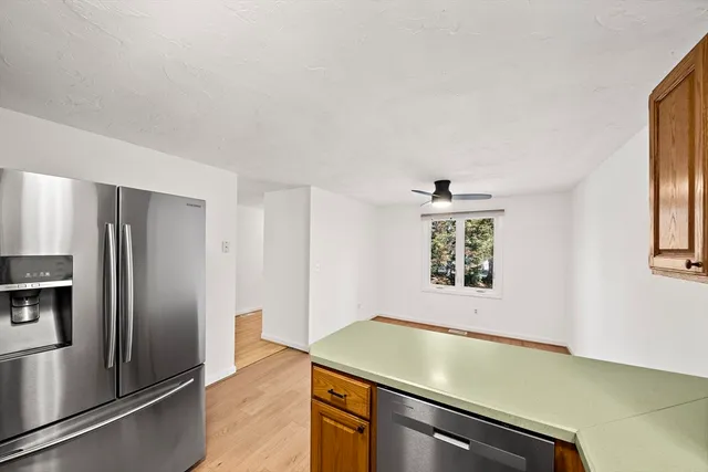 a view of a kitchen with a stove wooden floor and a window