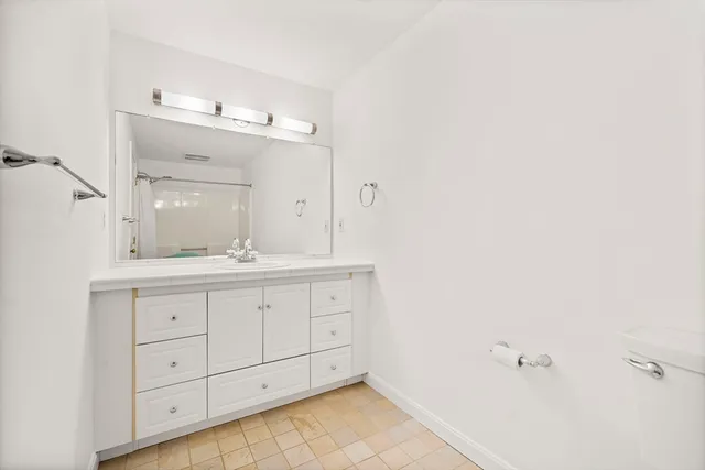 a bathroom with a double vanity sink and a mirror