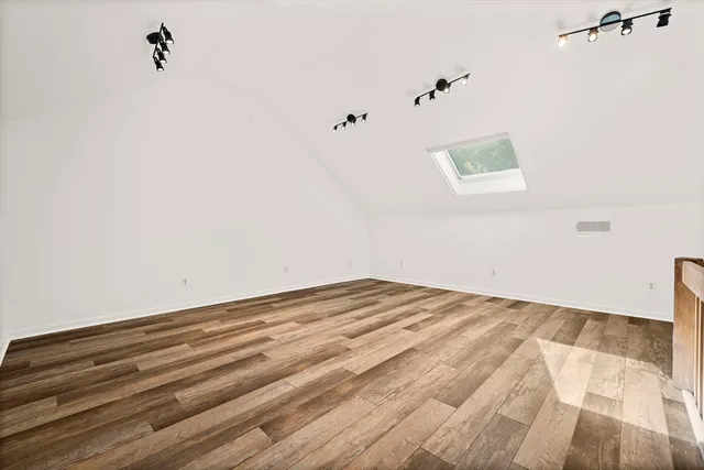 a view of a room with wooden floor and cabinet