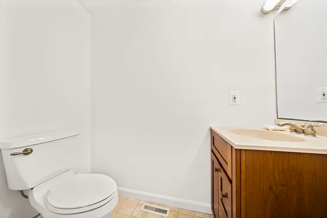a white toilet sitting next to a bathroom sink