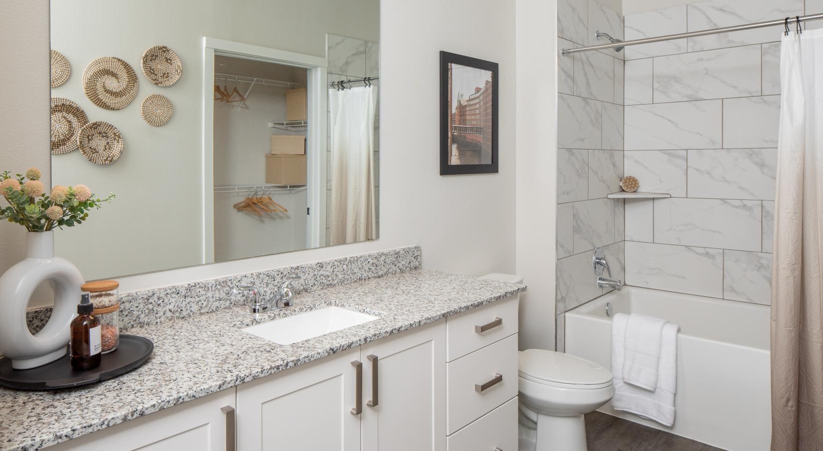 12111 South Main Street, Unit 10307 Houston, TX 77035 - Photo 13 of 24 a bathroom with a granite countertop sink mirror vanity and toilet