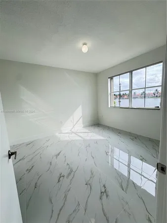 an empty room with a empty space and window