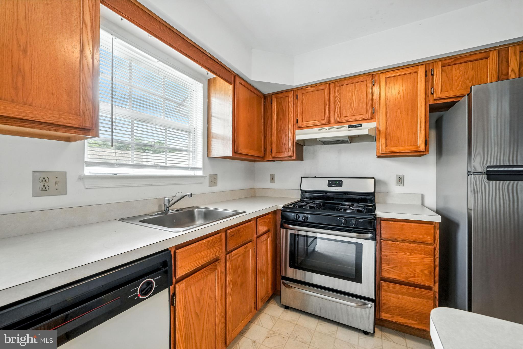 2002 Tall Pines Pine Hill, NJ 08021 - Photo 15 of 31 a kitchen with stainless steel appliances a stove a sink and a microwave