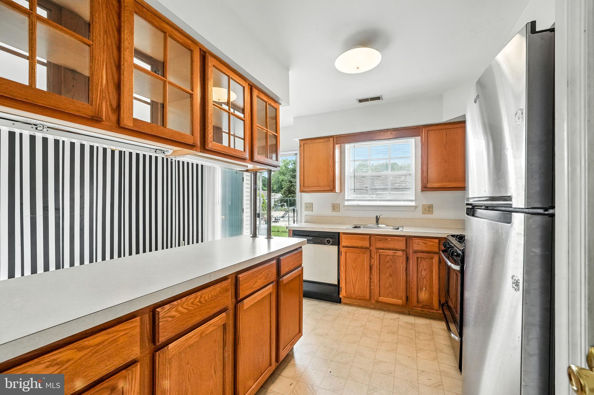 2002 Tall Pines Pine Hill, NJ 08021 - Photo 17 of 31 a kitchen with stainless steel appliances granite countertop a refrigerator and a sink