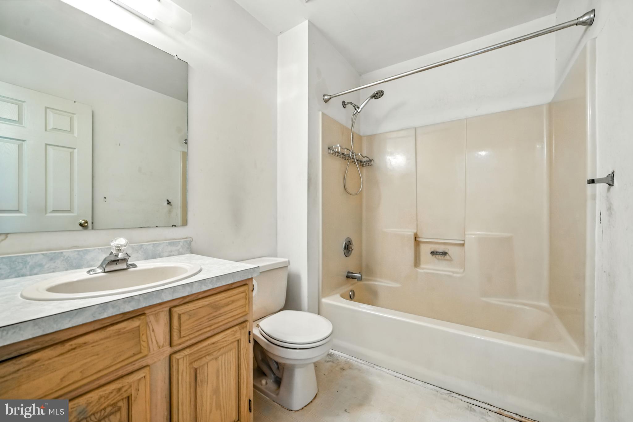 2002 Tall Pines Pine Hill, NJ 08021 - Photo 22 of 31 a bathroom with a sink a toilet a mirror a bathtub and shower