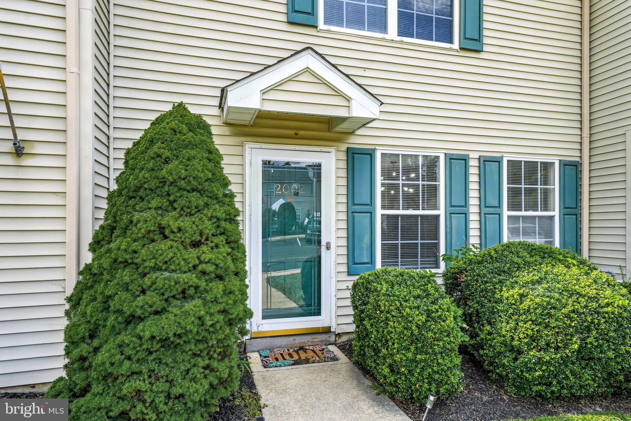 2002 Tall Pines Pine Hill, NJ 08021 - Photo 3 of 31 a front view of a house with a garden