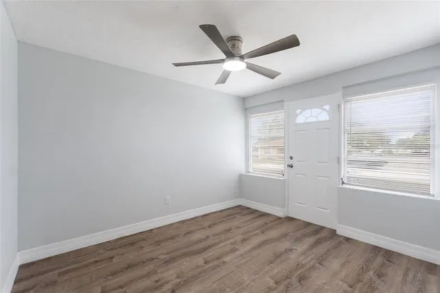 wooden floor in an empty room with a window