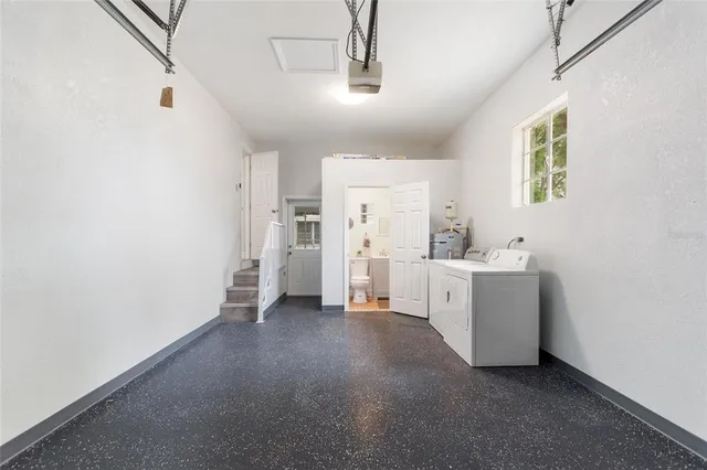 a view of a kitchen with white cabinets and white appliances