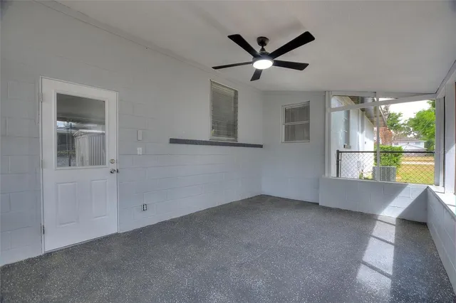 a view of a livingroom with a ceiling fan and window