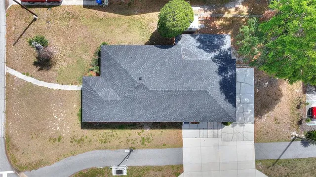 an aerial view of a house with a yard