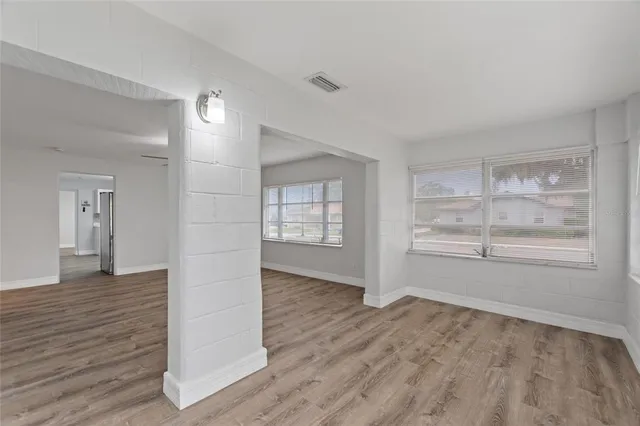 wooden floor in an empty room with a window