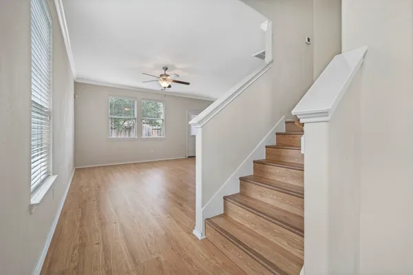 a view of entryway and hall with wooden floor