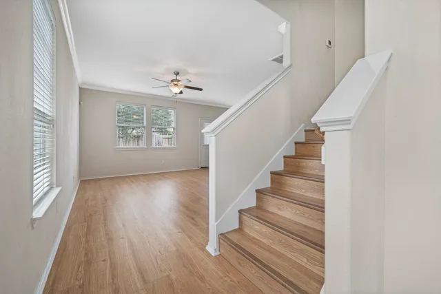 a view of entryway and hall with wooden floor