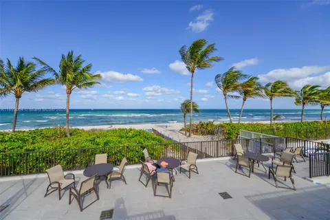 a view of a patio with a table and chairs