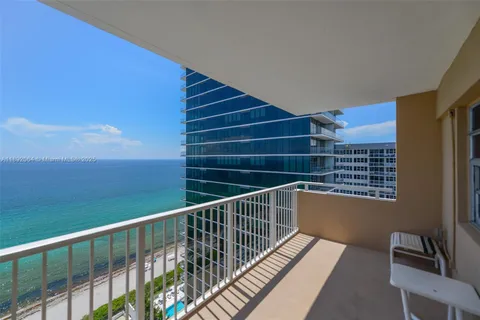a view of balcony with wooden floor and windows