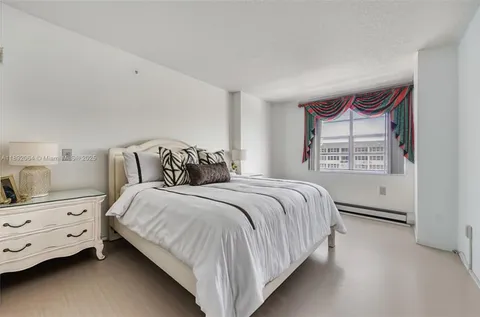 a bedroom with a bed and a night stand