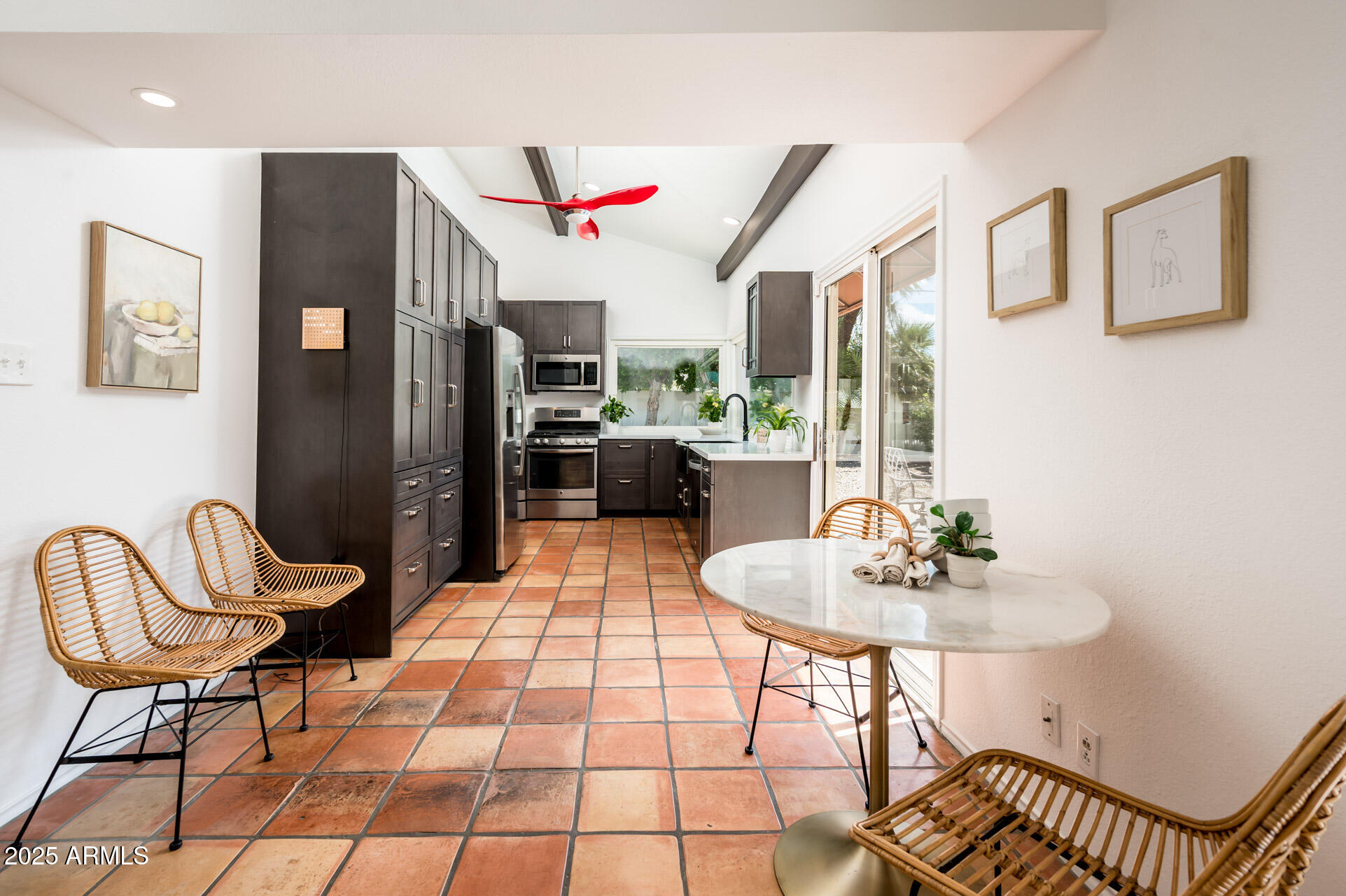 1224 East Rancho Drive Phoenix, AZ 85014 - Photo 16 of 38 a dining room with furniture and a chandelier
