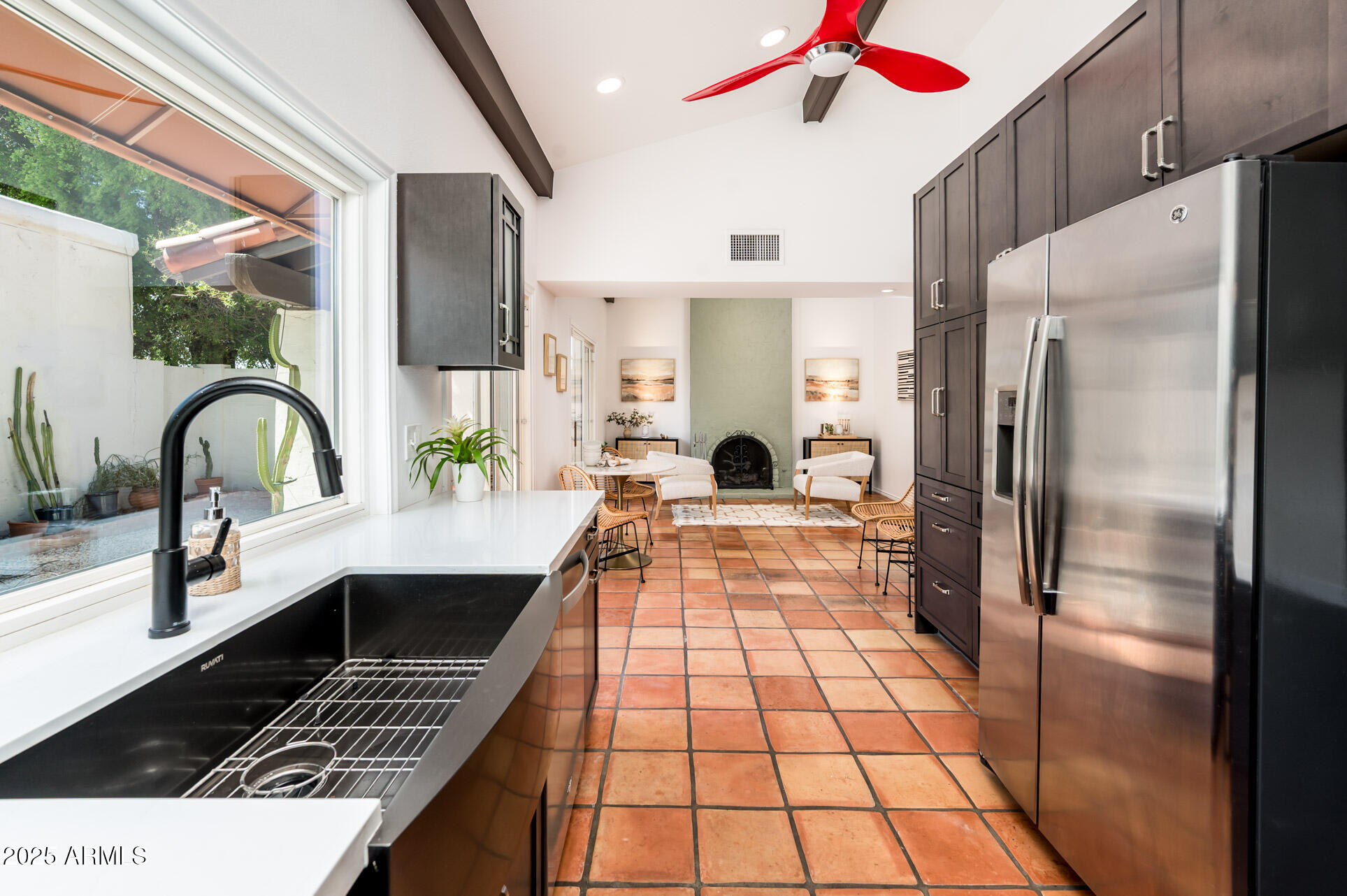 1224 East Rancho Drive Phoenix, AZ 85014 - Photo 19 of 38 a kitchen with stainless steel appliances kitchen island granite countertop a refrigerator and a stove
