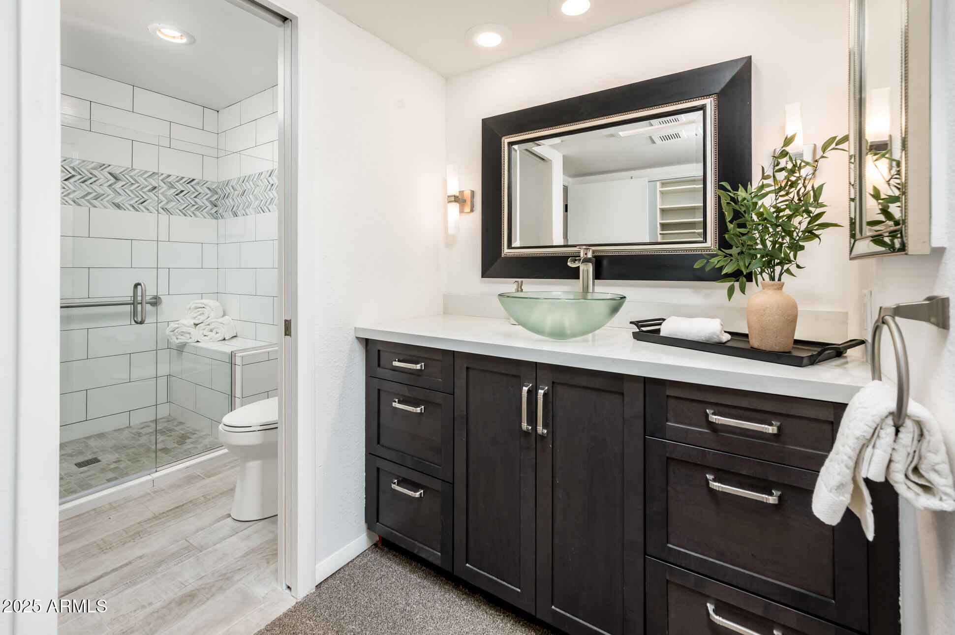 1224 East Rancho Drive Phoenix, AZ 85014 - Photo 23 of 38 a bathroom with a granite countertop sink toilet a large mirror a vanity and shower