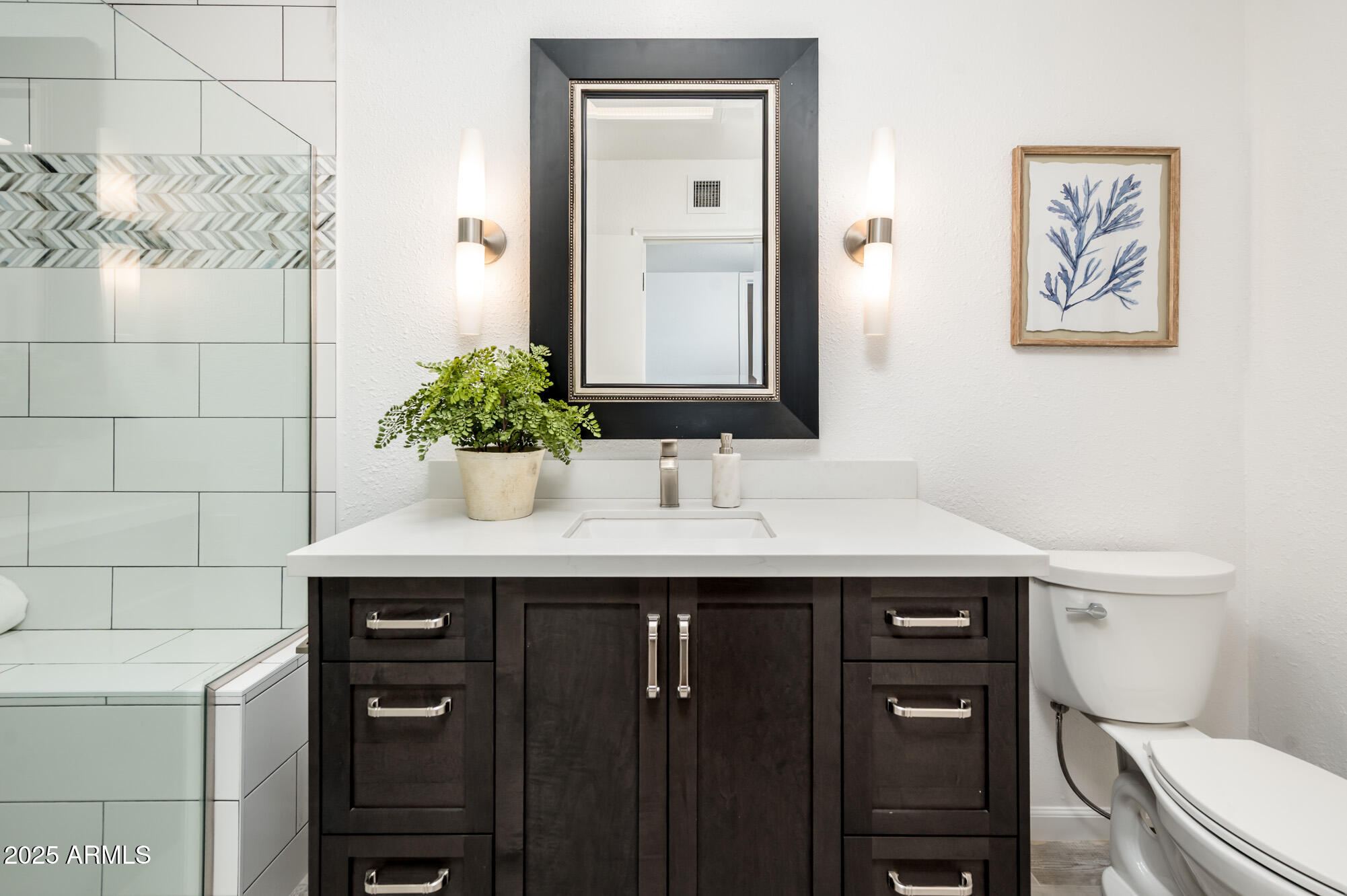 1224 East Rancho Drive Phoenix, AZ 85014 - Photo 27 of 38 a bathroom with a toilet sink and mirror
