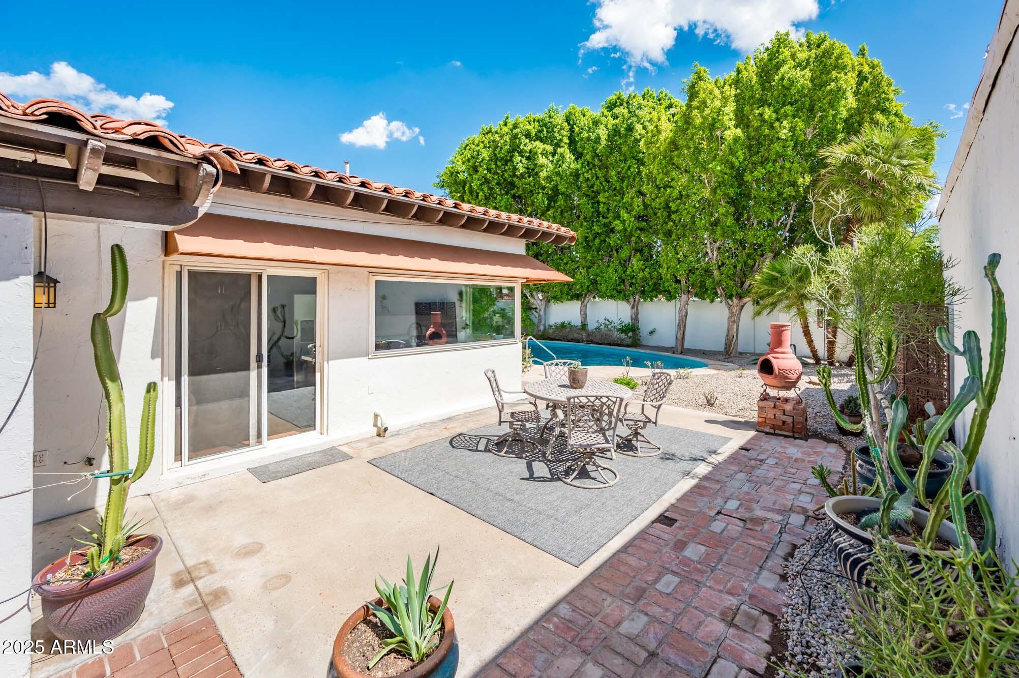 1224 East Rancho Drive Phoenix, AZ 85014 - Photo 37 of 38 a view of a patio with table and chairs and potted plants