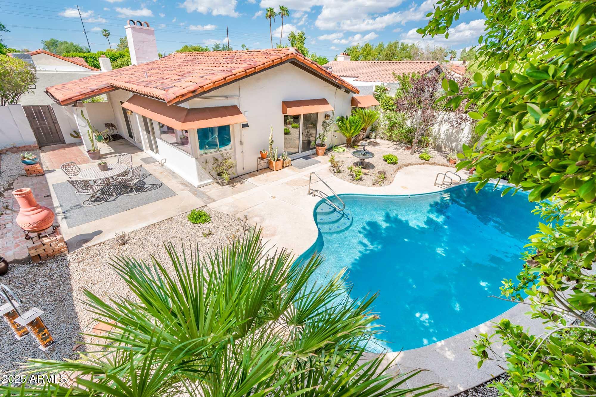 1224 East Rancho Drive Phoenix, AZ 85014 - Photo 4 of 38 a view of a patio with table and chairs potted plants