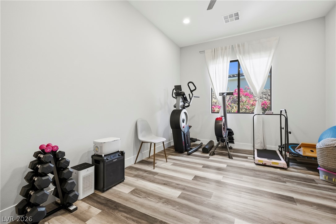 45 Garibaldi Way Henderson, NV 89011 - Photo 7 of 74 An inviting room, naturally illuminated, with resilient vinyl flooring, providing an ideal setting for a home fitness area.