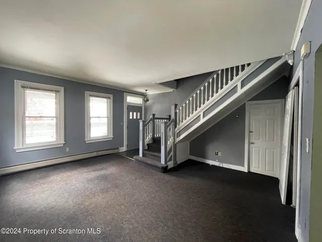 a view of an empty room with stairs