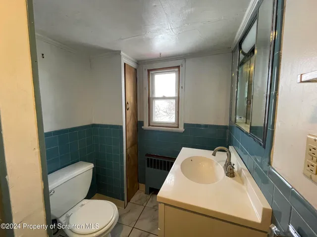 a bathroom with a sink a toilet and tub