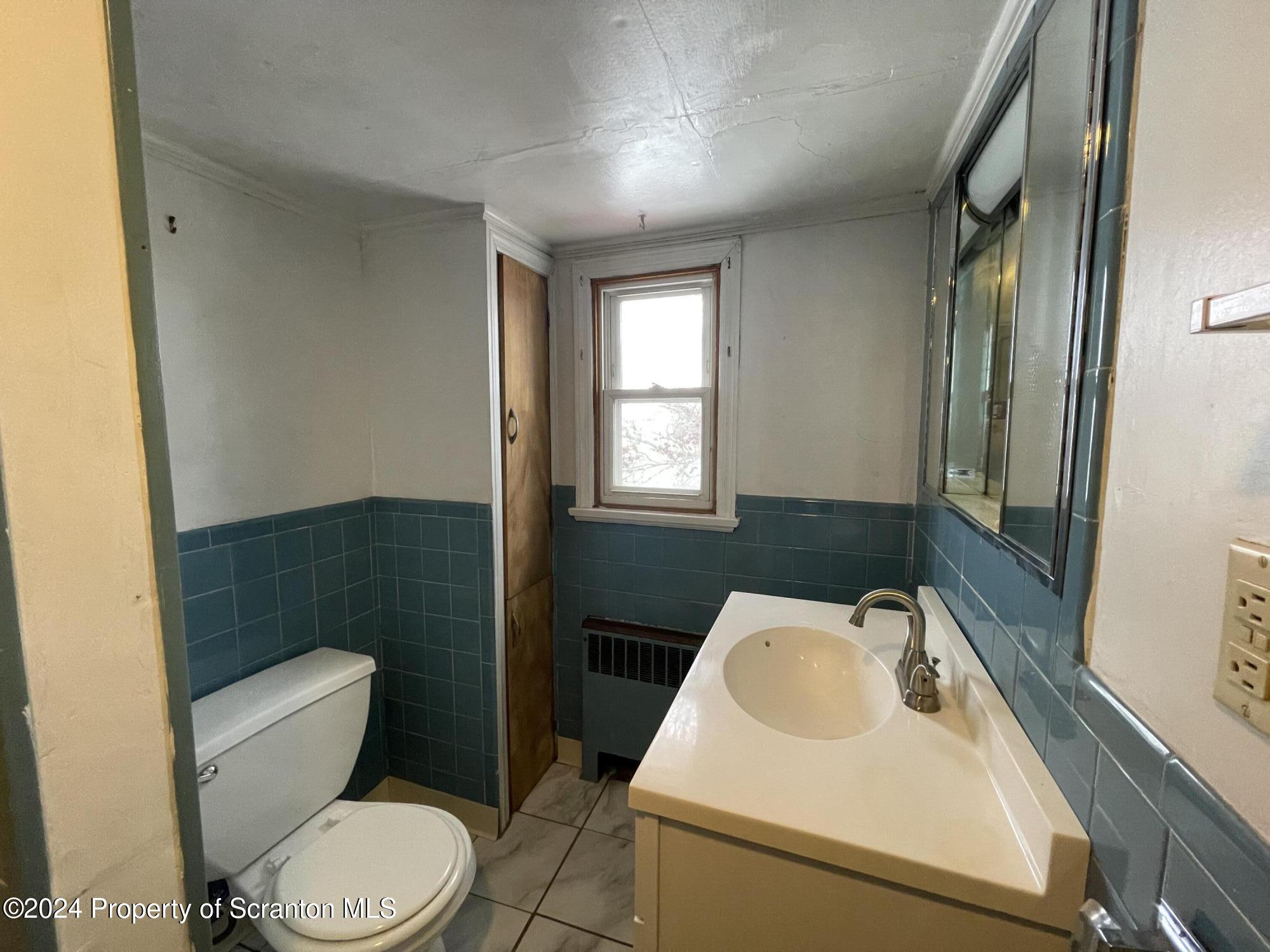 1230 Providence Road, Unit 2 Scranton, PA 18508 - Photo 9 of 10 a bathroom with a sink a toilet and tub