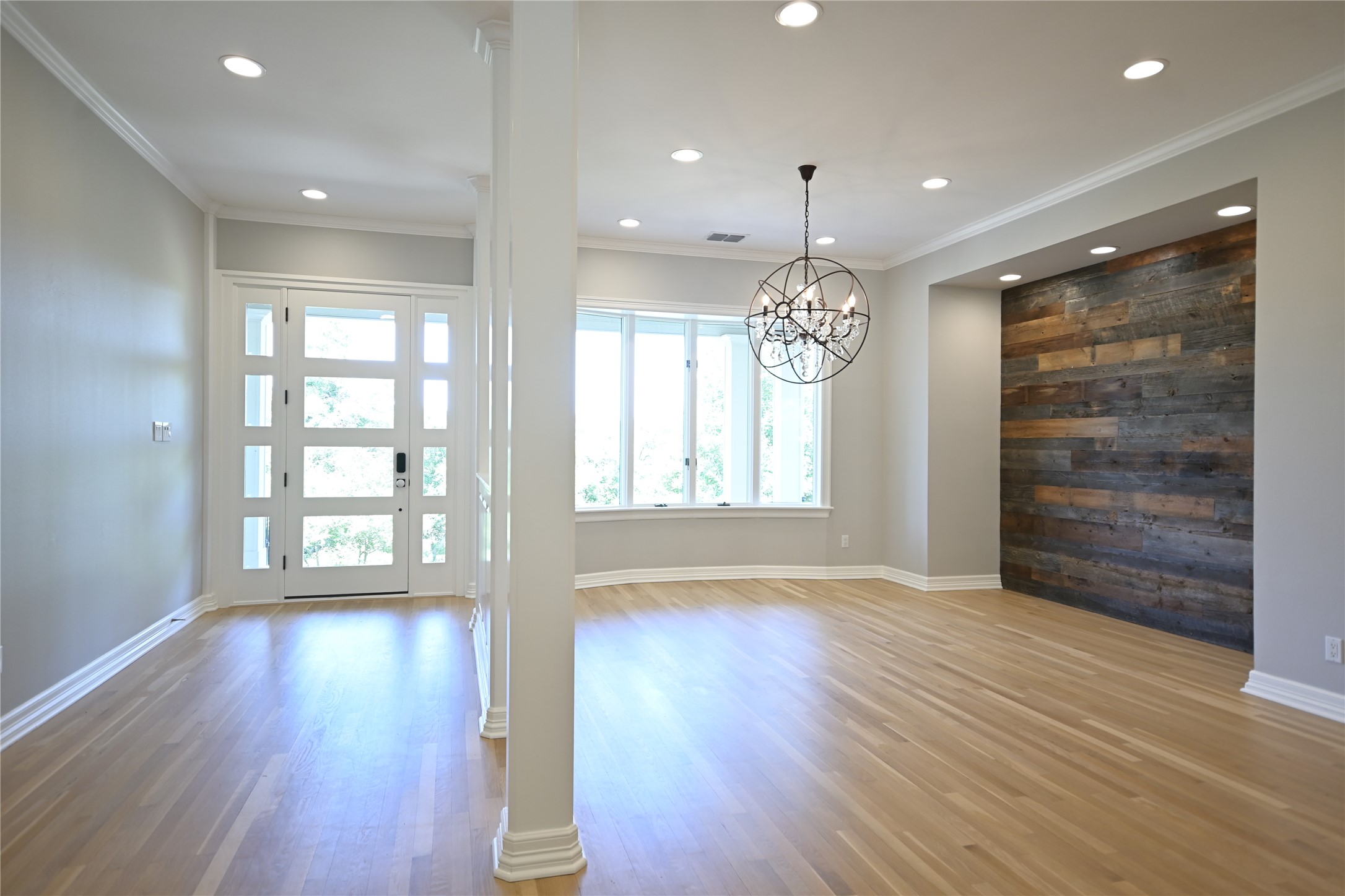 18 Ehrlich Road Austin, TX 78746 - Photo 21 of 36 Foyer with the beautiful entry door is adjacent to the dining room with the bay window overlooking the front porch and the view, and leads into the main lving area.